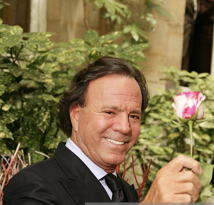 Singer Julio Iglesias promoting the "Julio Iglesias Rose" made by Meilland, in the summer garden of the Ritz hotel in Paris. (Photo by Stephane Cardinale/Corbis via Getty Images)